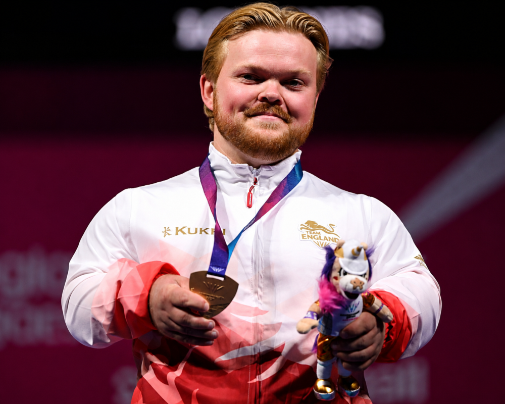 England's Mark Swan celebrates after winning the first gold medal of the Glasgow 2026 Commonwealth Games in the Men's Lightweight Para Powerlifting event.