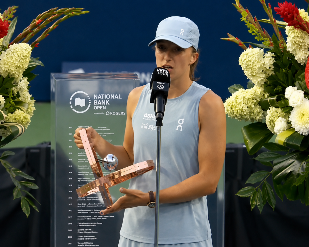 Iga Swiatek celebrates after winning the National Bank Open Toronto title and delivers an emotional message about unfair judgment and hate.