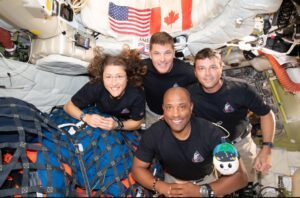 The Artemis II crew – (clockwise from left) Mission Specialist Christina Koch, Mission Specialist Jeremy Hansen, Commander Reid Wiseman, and Pilot Victor Glover – pause for a group photo with their zero gravity indicator "Rise," inside the Orion Image Credit: NASA