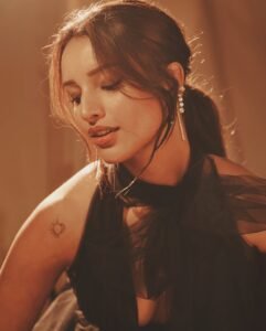 Triptii Dimri posing in a sheer black gown with a sultry gaze.